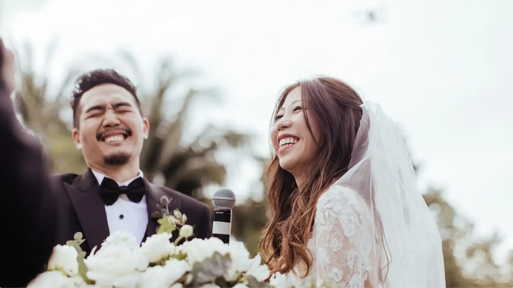 Bride and groom laughing together during their outdoor ceremony